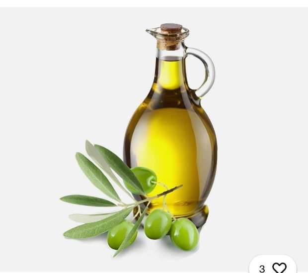 Glass carafe of golden extra virgin olive oil with a fresh branch of green olives on a white background