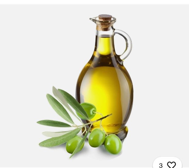 Glass carafe of golden extra virgin olive oil with a fresh branch of green olives on a white background
